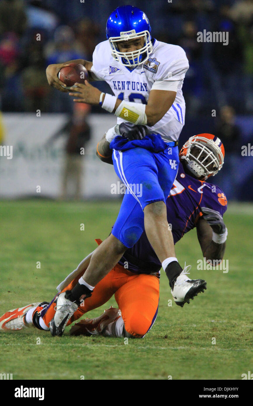 Kentucky quarterback Newton (12) attempts to break the tackle of