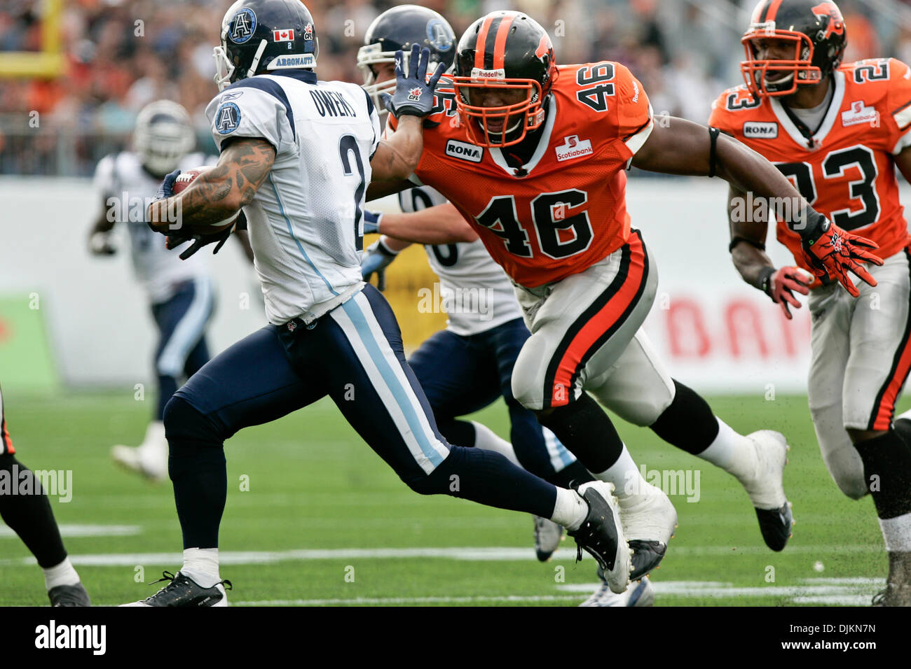 Sept. 11, 2010 - Vancouver, British Columbia, Canada - BC Lions #46 FB Rolly Lumbala reaches over to Toronto Argonauts #2 WR Chad Owens (Credit Image: © James Healey/Southcreek Global/ZUMApress.com) Stock Photo