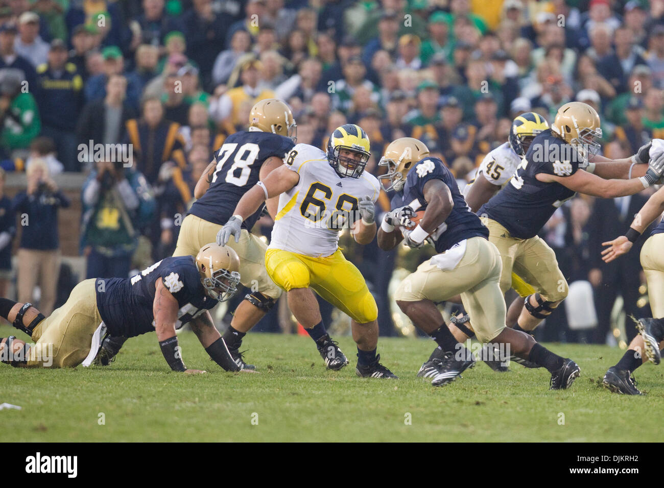 Sept. 11, 2010 - South Bend, Indiana, United States of America - Michigan defensive tackle Alex Schwab (#68) pursues Notre Dame tailback Jonas Gray (#25) during NCAA football game between the Notre Dame Fighting Irish and the Michigan Wolverines.  Michigan defeated Notre Dame 28-24 in game at Notre Dame Stadium in South Bend, Indiana. (Credit Image: © John Mersits/Southcreek Global Stock Photo