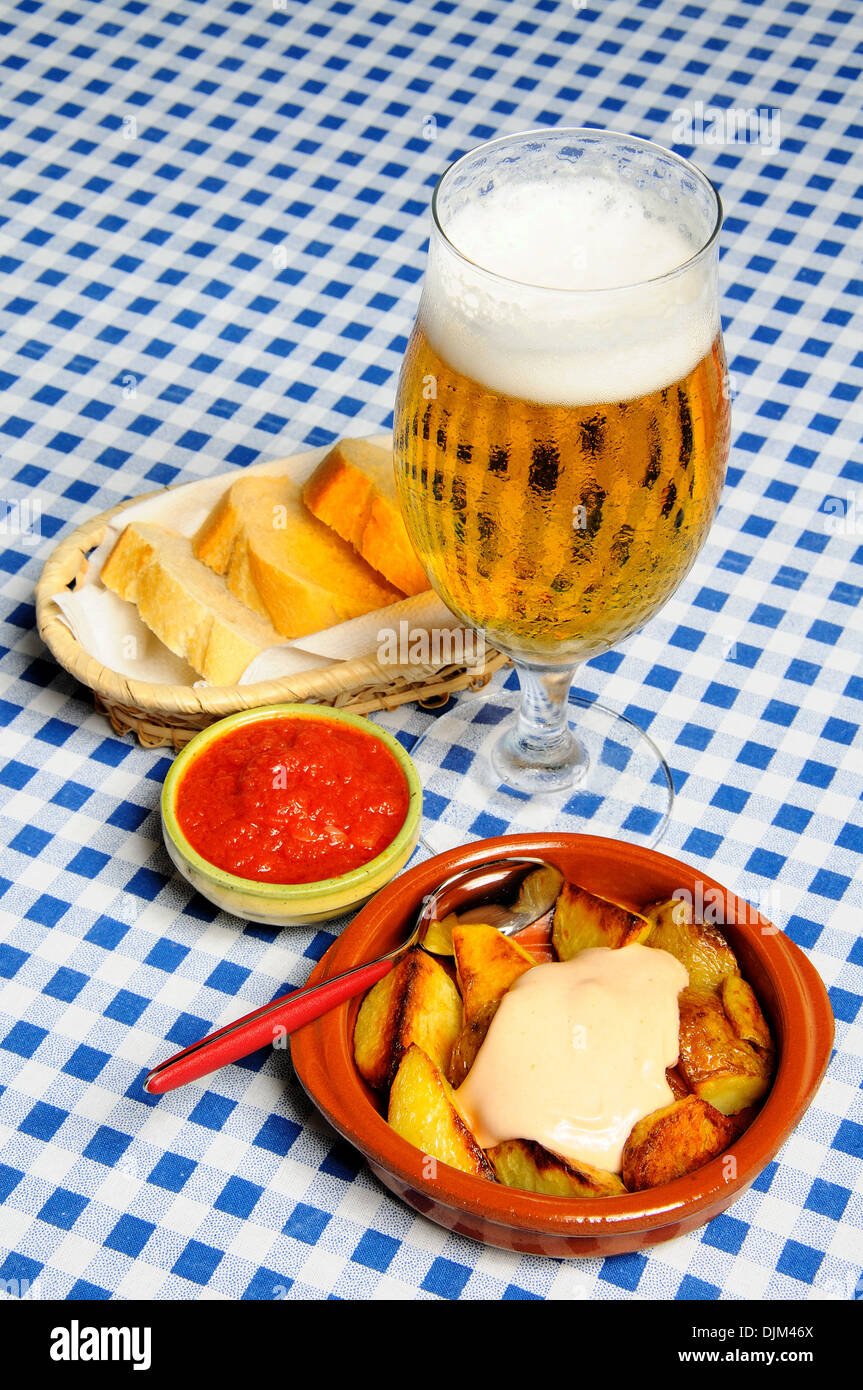 Tapas chipped potatoes with mayonnaise (Patatas Bravas) and spicy