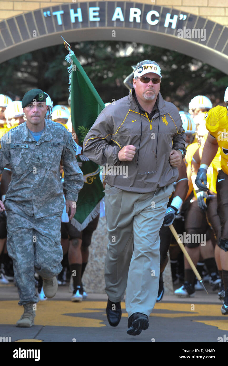 Sept. 18, 2010 - Laramie, Wyoming, United States of America - Wyoming head coach Dave Christensen enters the stadium after passing through ''The Arch'' before Boise State defeated Wyoming, 51-6, at War Memorial Stadium. (Credit Image: © Andrew Fielding/Southcreek Global/ZUMApress.com) Stock Photo