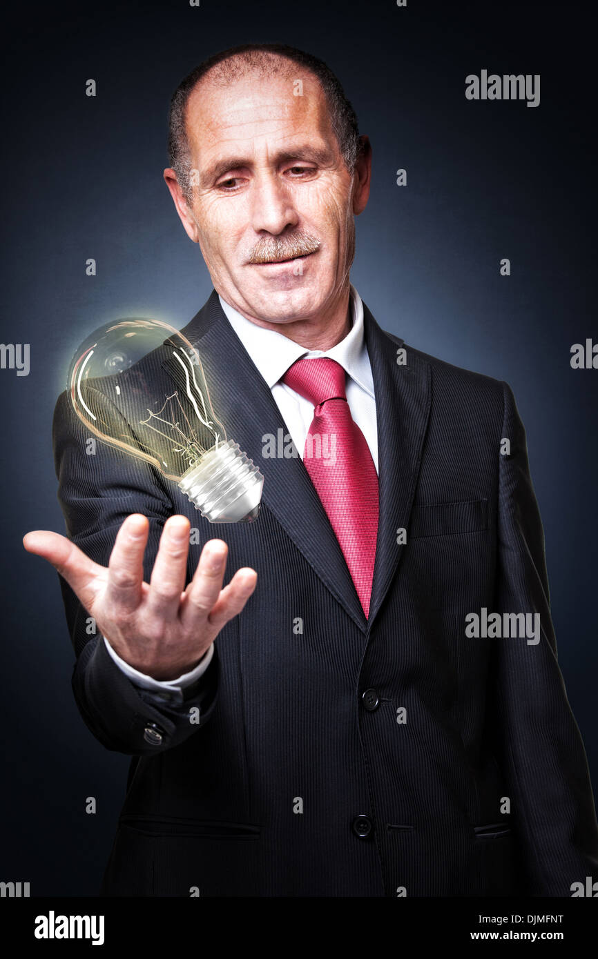 portrait of senior and electric bulb Stock Photo Alamy