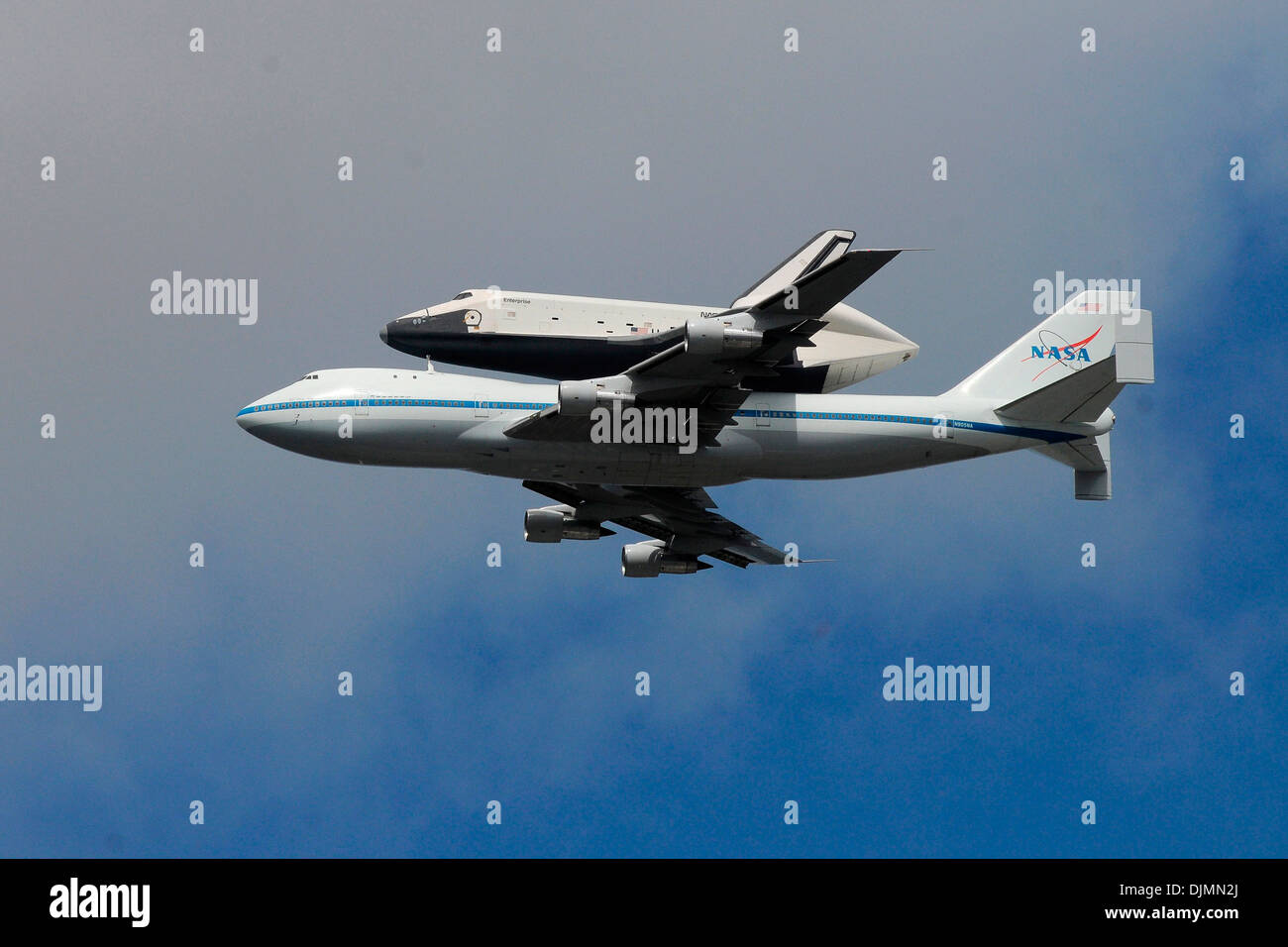 The space shuttle Enterprise flies over New York City strapped on a