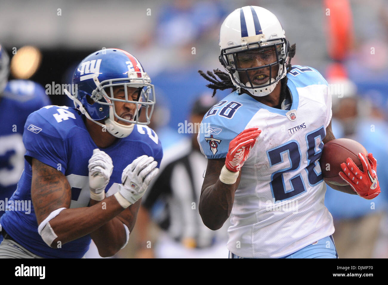 New York Giants cornerback Terrell Thomas (24) pushes Tennessee Titans  running back Chris Johnson (28) out of bounds after a 42-yard run during  fourth quarter NFL football action between the New York