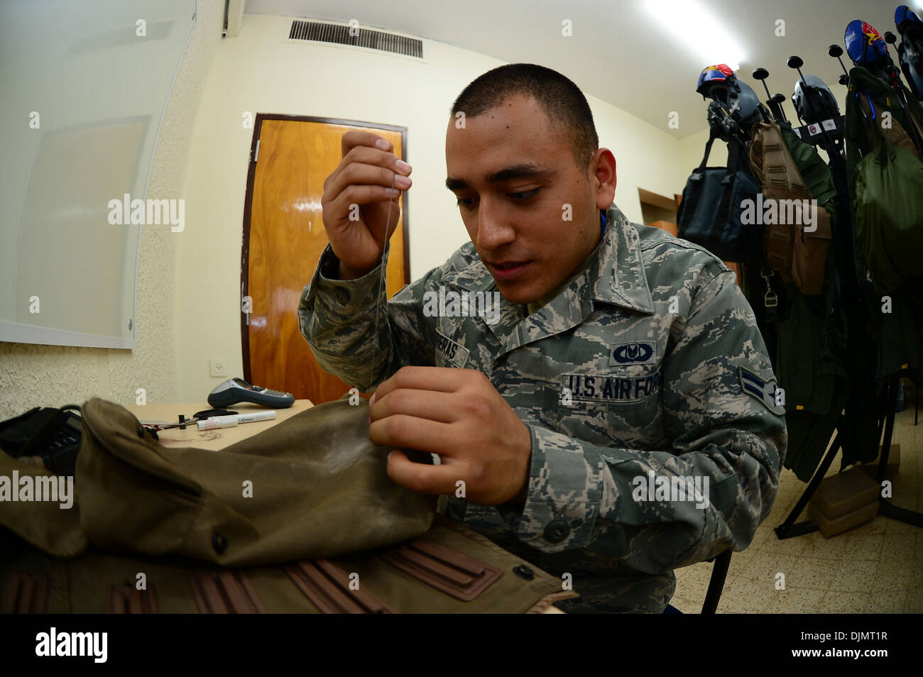 Airman 1st Class Roman Contreras, 492nd Fighter Squadron, aircrew flight equipment technician, stitches together a tear on a sur Stock Photo