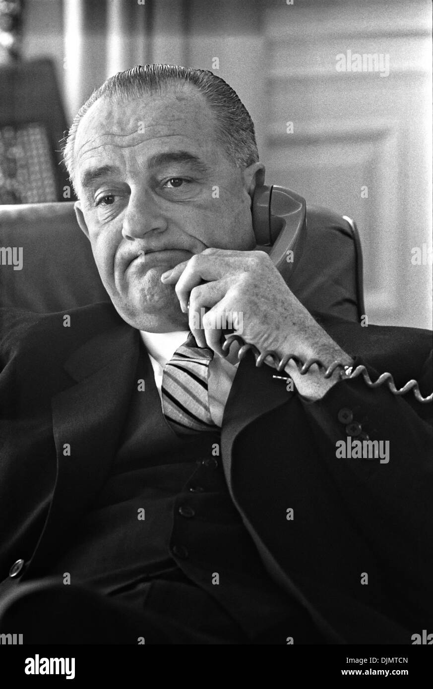 US President Lyndon B. Johnson speaks on the telephone from the Oval Office of the White House January 10, 1964 in Washington, DC. Stock Photo
