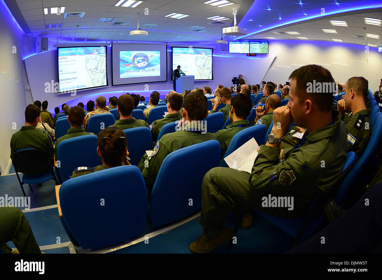 Exercise participants from the U.S., Israel, Greece, and Italy along with other distinguished visitors attend a Blue Flag exercise mass briefing at Uvda Air Force Base, Israel Nov. 25, 2013. Blue Flag was a multinational aerial warfare exercise hosted by Stock Photo
