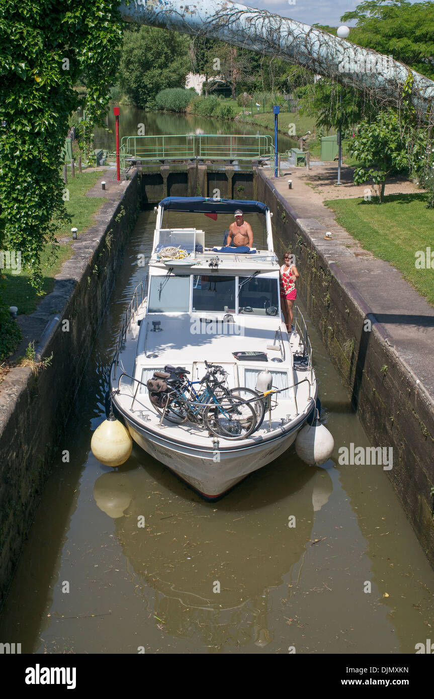 Canal boat passing through lock on the Canal du Centre Burgundy eastern France Stock Photo
