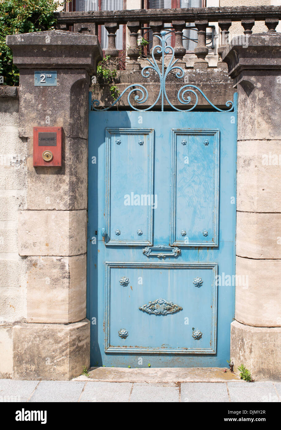 Faded blue metal gate to garden of house in Chagny eastern France Stock Photo