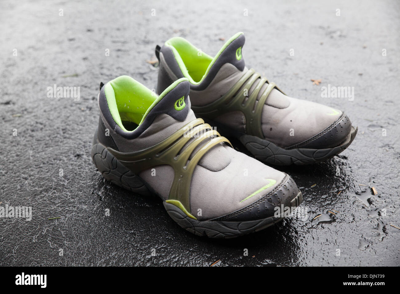 A pair of casual walking shoes on an asphalt road Stock Photo