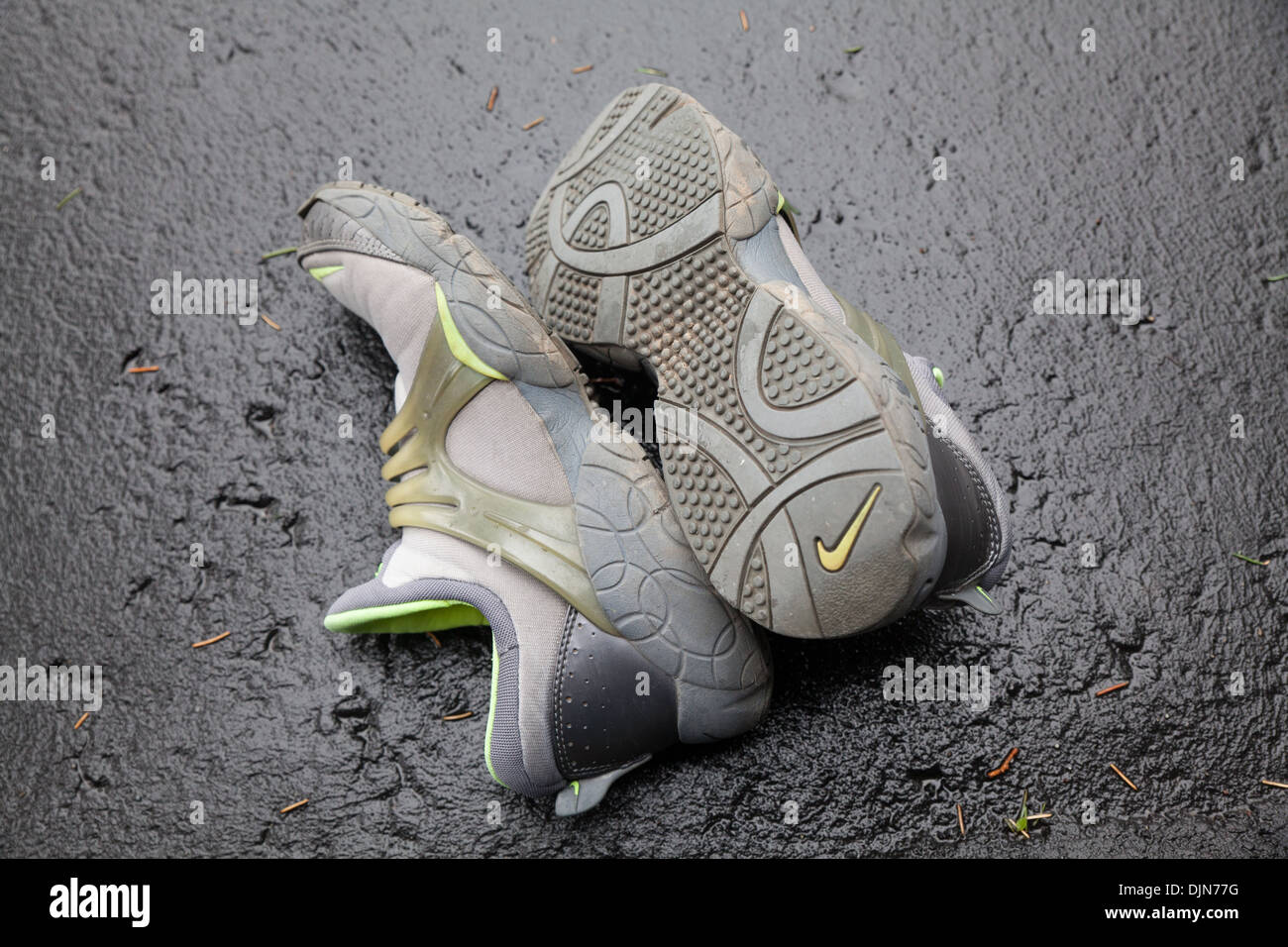 dirty nike running shoes on the ground Stock Photo - Alamy