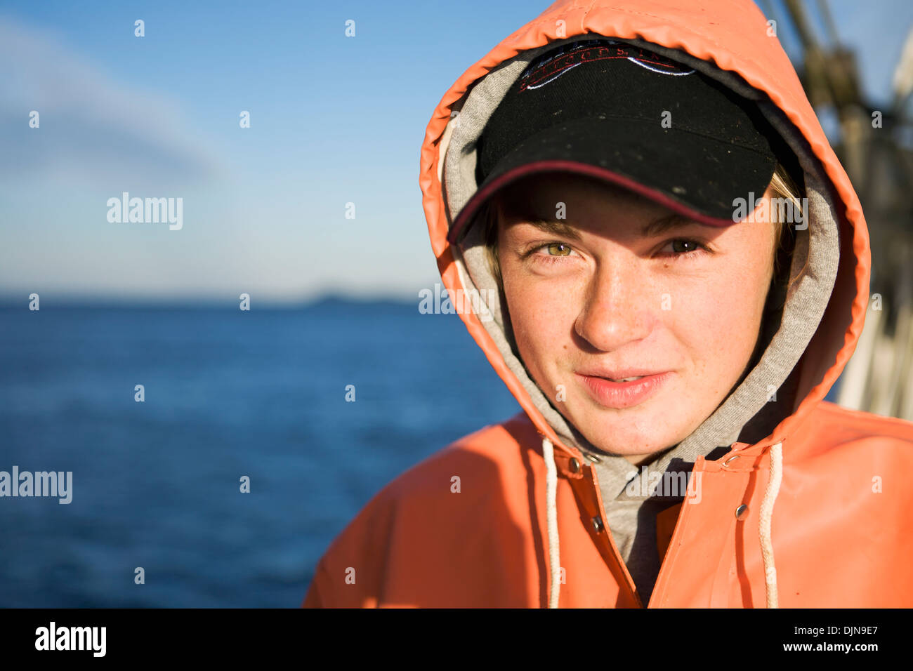 Portriat Of Emma Laukitis In Her Raingear While Commercial Halibut Fishing In Southwest Alaska, Summer. Stock Photo