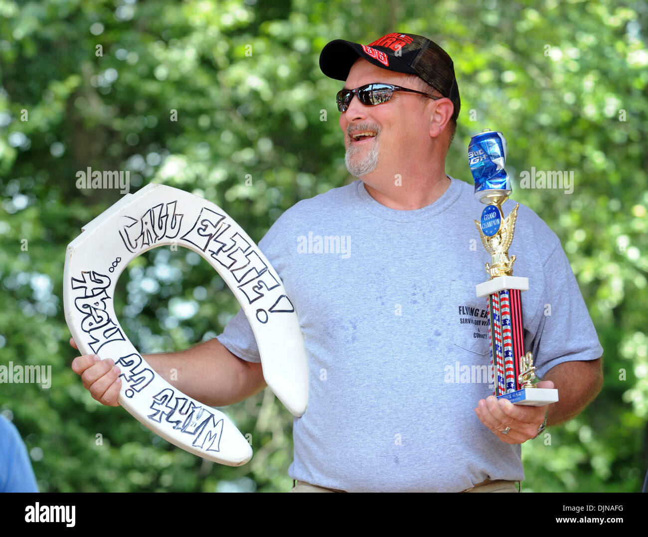 Mar 11, 2008 - East Dublin, Georgia, USA - Ryan 'Iceberg' Berg holds his trophies after winning the Redneck Horseshoes competition during the 13th annual Summer Redneck Games at Buckeye Park in East Dublin, Georgia, on Saturday. The annual homage to Southerners, began as a spoof to the 1996 Summer Olympics in Atlanta. Thousands of revelers attend the event whose events include bobb Stock Photo