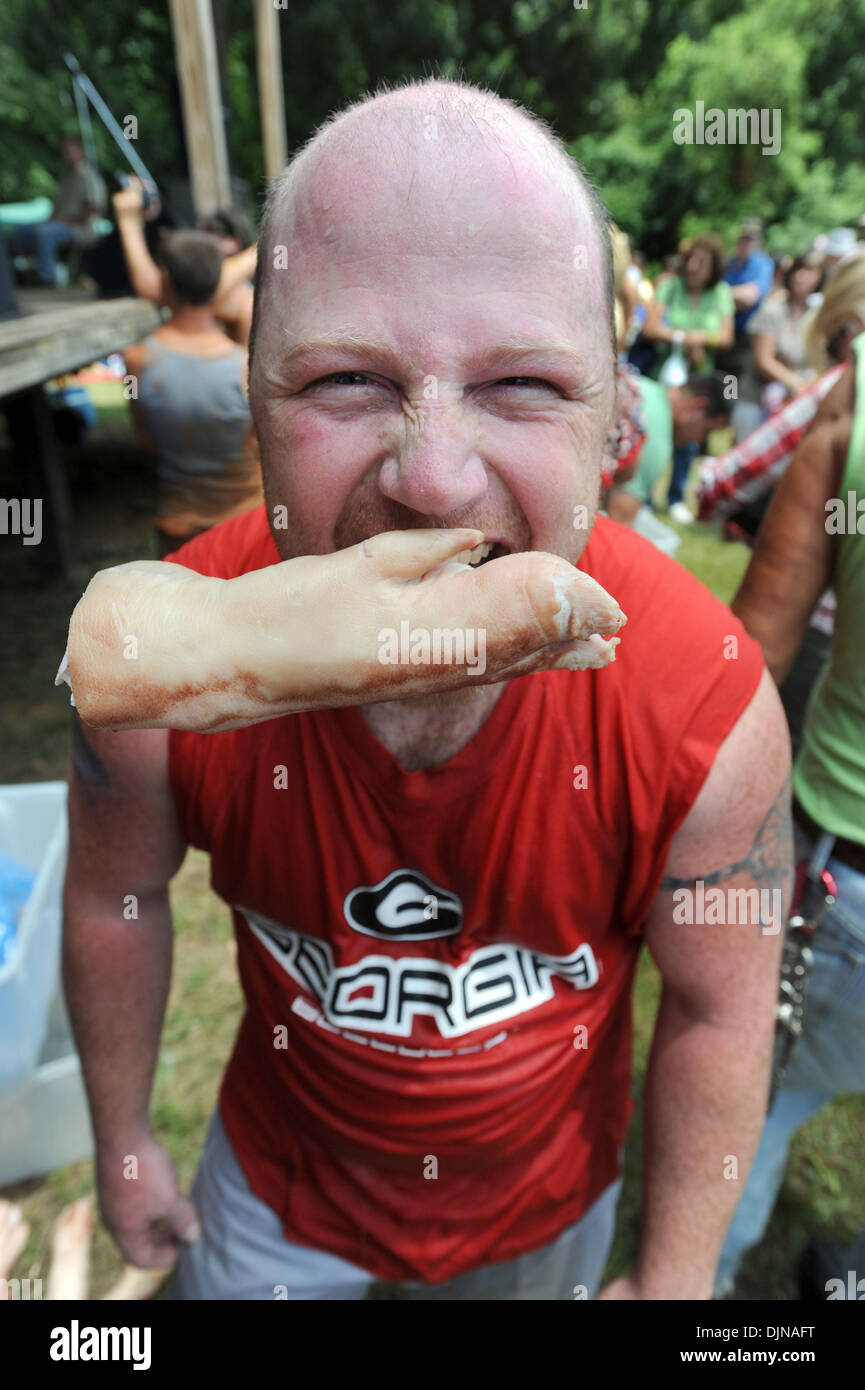 Mar 11, 2008 - East Dublin, Georgia, USA - Bobbing for Pigs Feet winner Eric Outler, left, celebrates his victory during the 13th annual Summer Redneck Games at Buckeye Park in East Dublin, Georgia, on Saturday. The annual homage to Southerners, began as a spoof to the 1996 Summer Olympics in Atlanta. Thousands of revelers attend the event whose events include bobbing for pigs feet Stock Photo