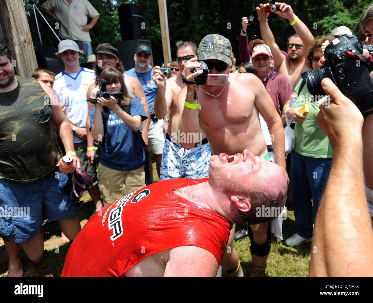 Mar 11, 2008 - East Dublin, Georgia, USA - Bobbing for Pigs Feet winner Eric Outler celebrates his victory during the 13th annual Summer Redneck Games at Buckeye Park in East Dublin, Georgia, on Saturday. The annual homage to Southerners, began as a spoof to the 1996 Summer Olympics in Atlanta. Thousands of revelers attend the event whose events include bobbing for pigs feet, the m Stock Photo