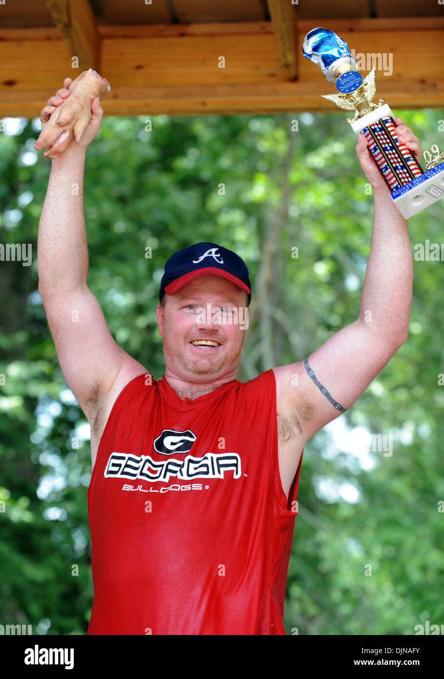 Mar 11, 2008 - East Dublin, Georgia, USA - Bobbing for Pigs Feet winner Eric Outler celebrates his victory during the 13th annual Summer Redneck Games at Buckeye Park in East Dublin, Georgia, on Saturday. The annual homage to Southerners, began as a spoof to the 1996 Summer Olympics in Atlanta. Thousands of revelers attend the event whose events include bobbing for pigs feet, the m Stock Photo