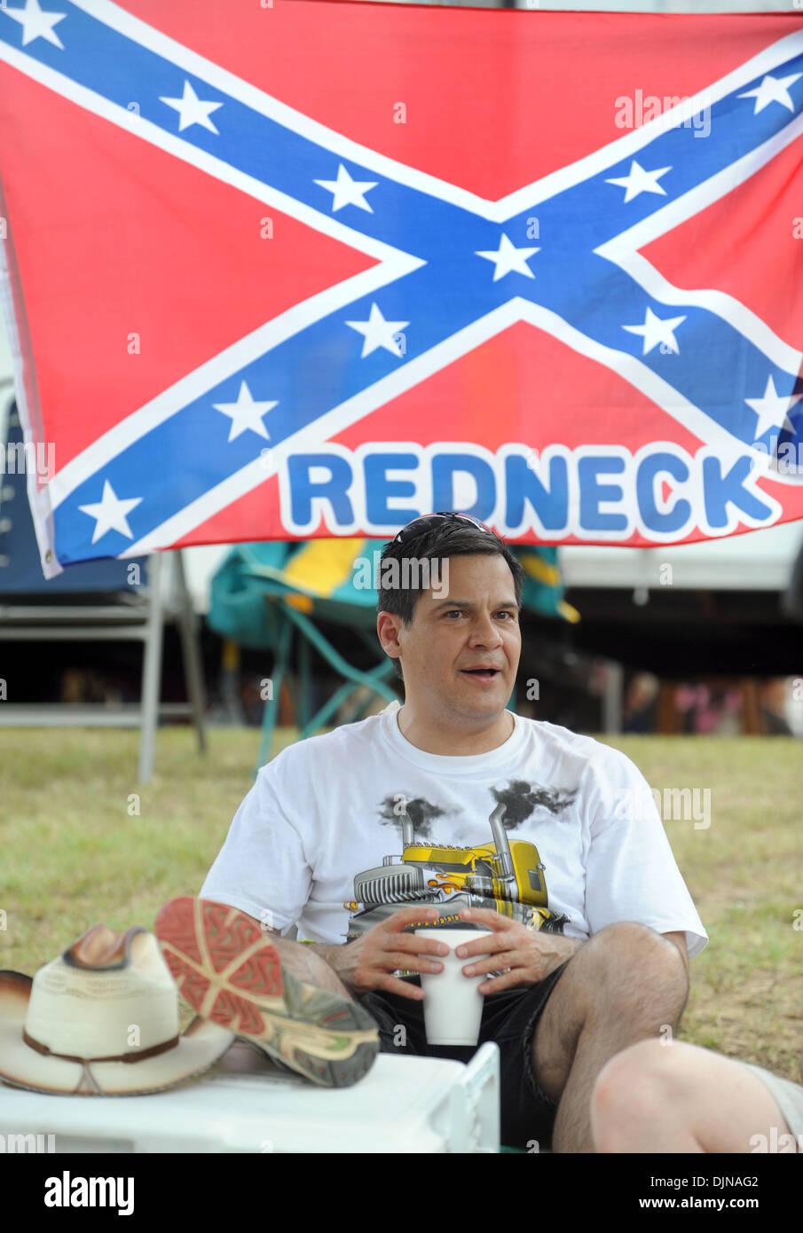 Mar 11, 2008 - East Dublin, Georgia, USA - Paul Pasier watches the activities during the 13th annual Summer Redneck Games at Buckeye Park in East Dublin, Georgia, on Saturday. The annual homage to Southerners, began as a spoof to the 1996 Summer Olympics in Atlanta. Thousands of revelers attend the event whose events include bobbing for pigs feet, the mud pit belly flop and armpit  Stock Photo
