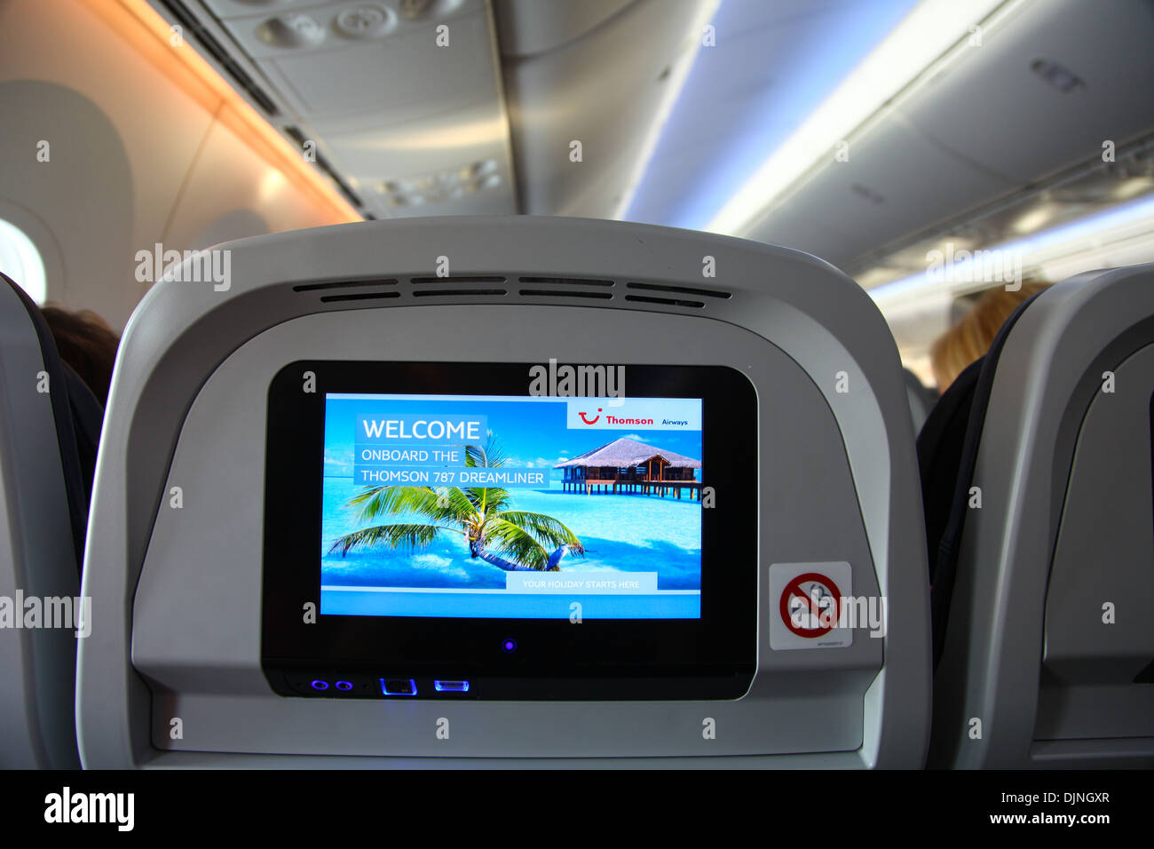 Interior of a Boeing 787 Dreamliner Thompson airways aircraft showing the individual passenger in flight entertainment screen Stock Photo