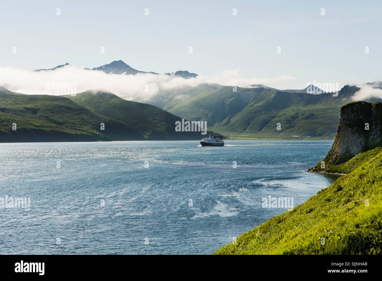 The Alaska Marine Highway Ferry M/V Tustumena Motoring Through False Pass At The Edge Of The Aleutian Islands Stock Photo