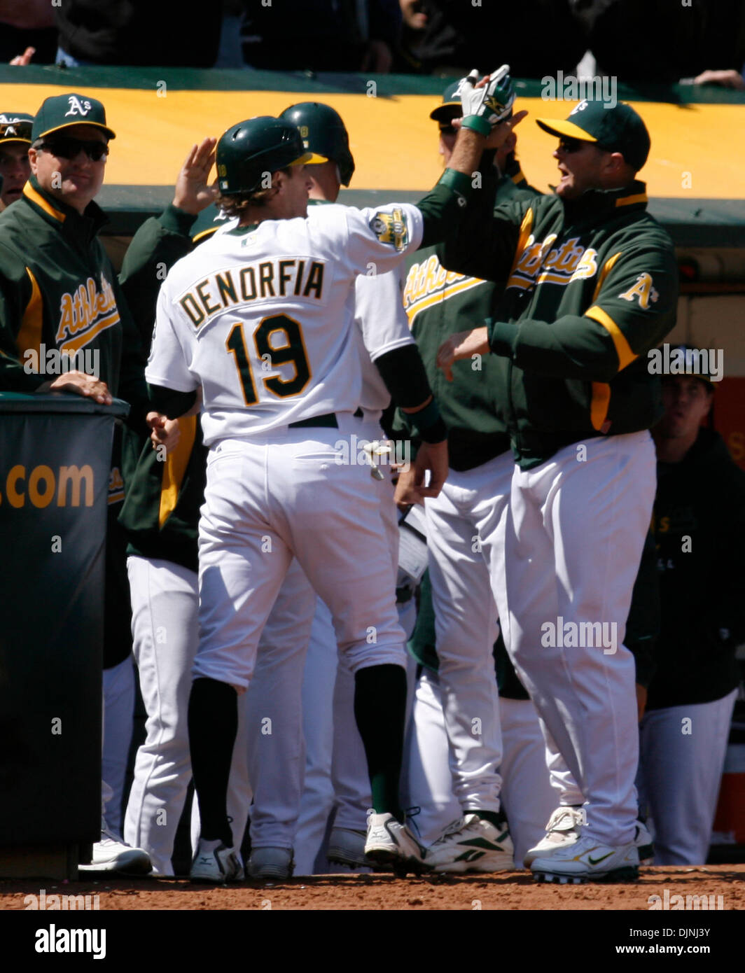 Oakland Athletics' Chris Denorfia (19) gets congratulations from his