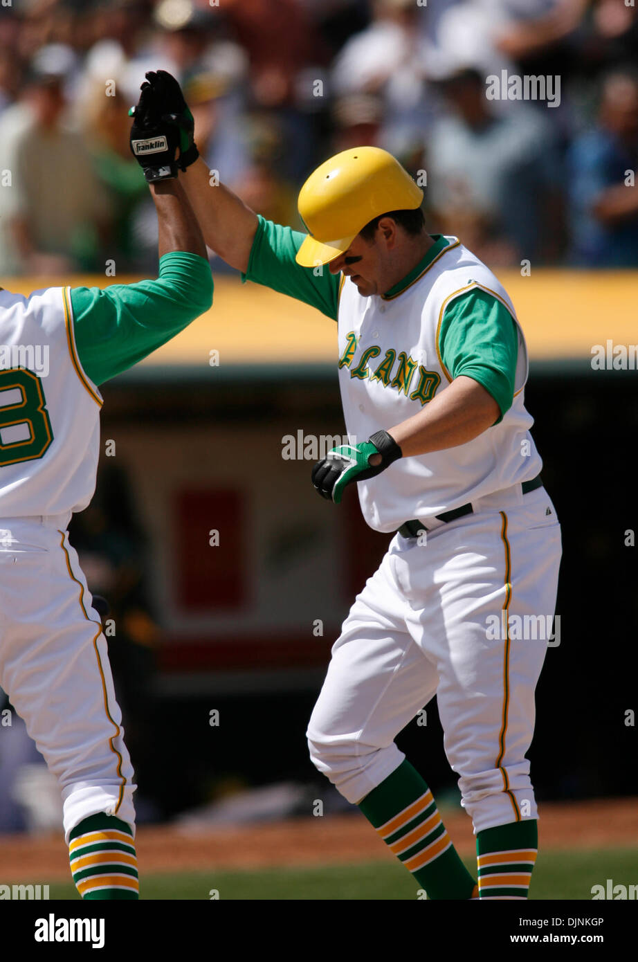 Oakland Athletics' Jack Cust gets a high five after hitting a two