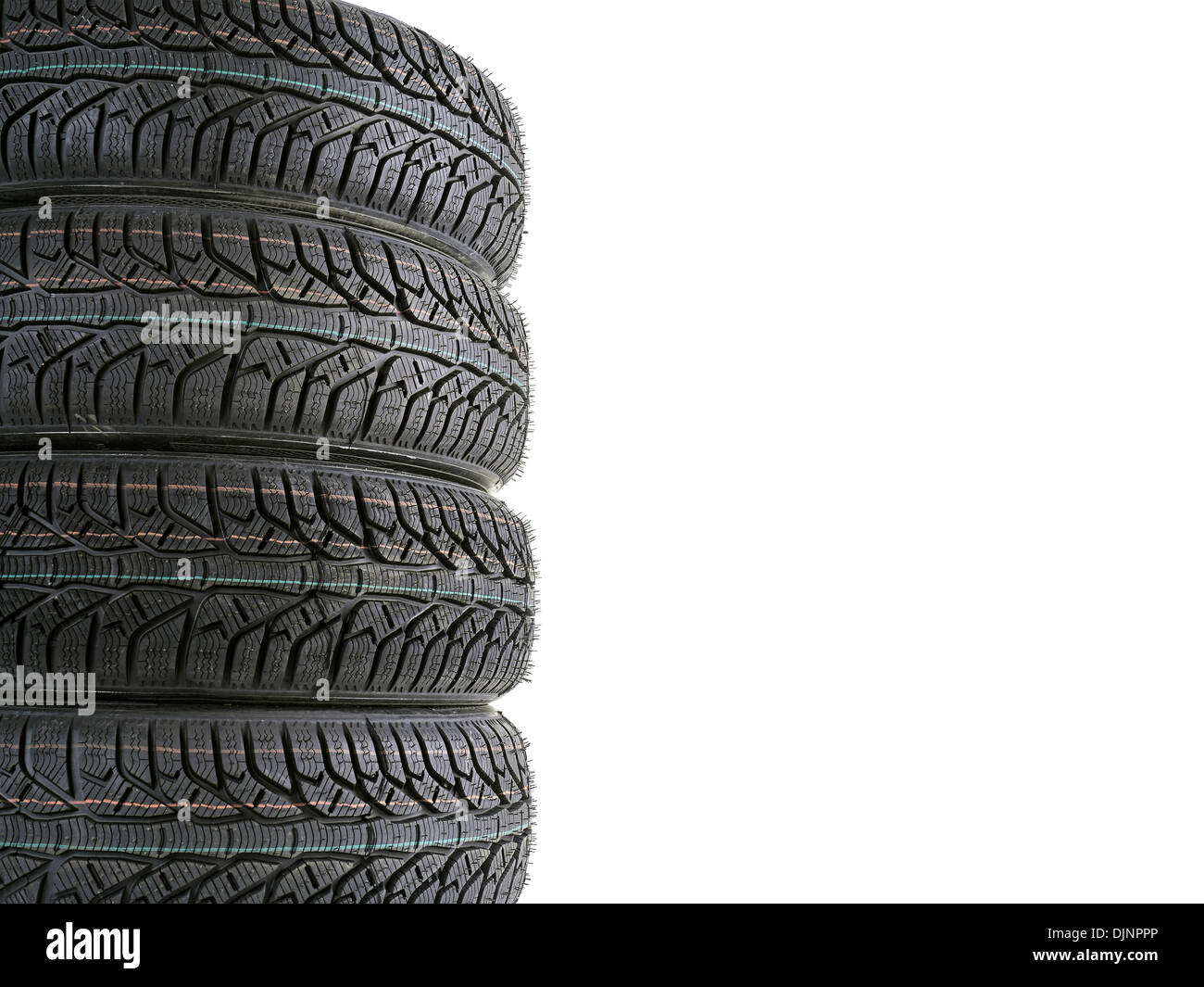 Pile of four winter car tires with white copy space Stock Photo