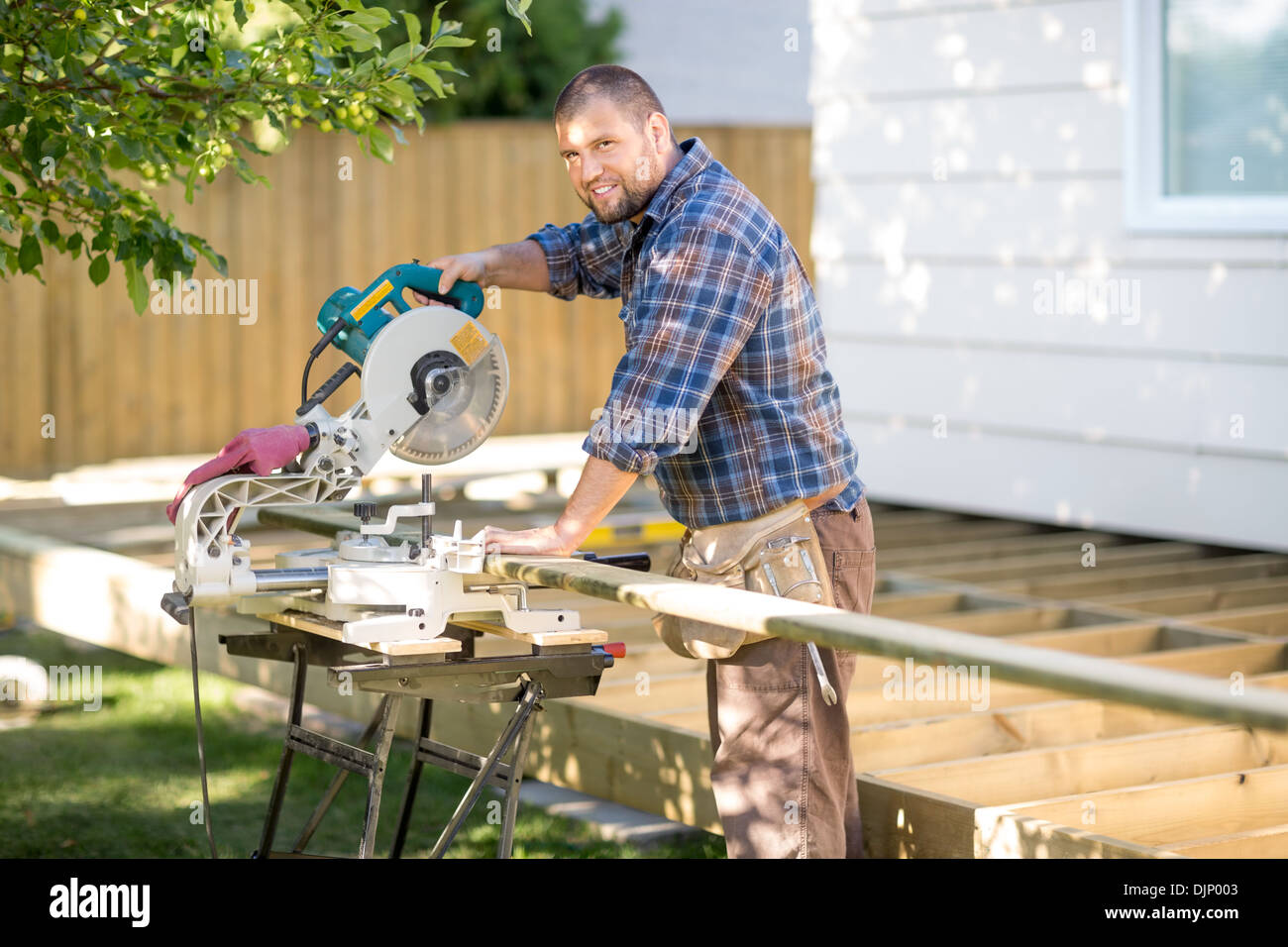 Carpenter Cutting Wood Using Table Saw 