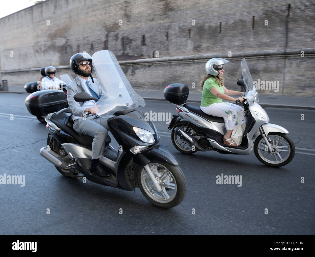 Business man and woman on Vespas, Vatican area, Rome Stock Photo