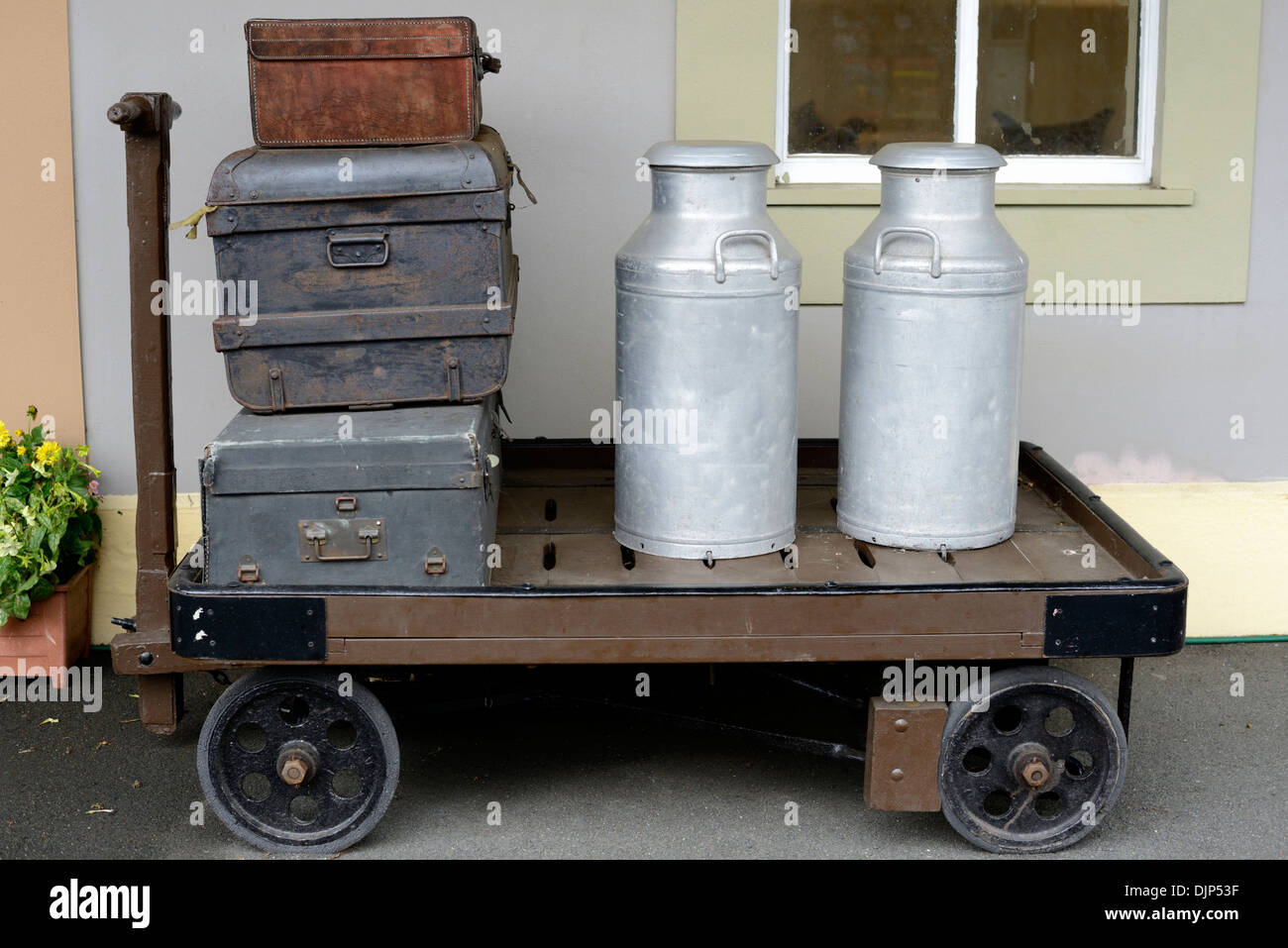 Old Leather Suitcases & Milk Churns on a Trolley at Churston Railway Station Platform in Devon, England. Stock Photo