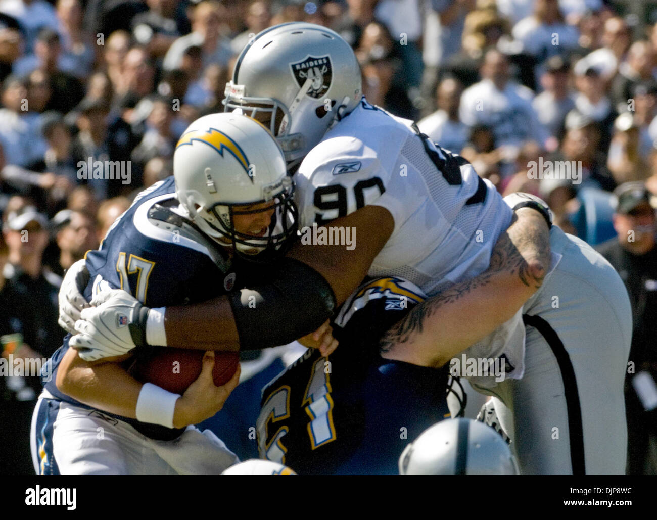 Sep 28, 2008 - OAKLAND, CA, USA - Oakland Raiders defensive tackle TERDELL SANDS #90 sacks San Diego Chargers quarterback PHILIP RIVERS #17 during a game at McAfee Coliseum. (Credit Image: © AL GOLUB/Golub Photography/Golub Photography) Stock Photo