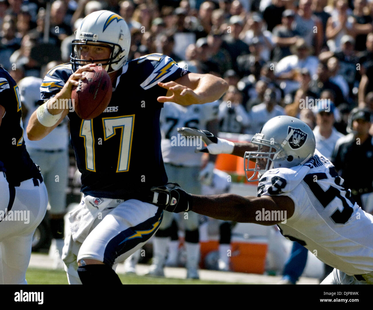 Sep 28, 2008 - OAKLAND, CA, USA - Oakland Raiders defensive end KALIMBA EDWARDS #58 forces San Diego Chargers quarterback PHILIP RIVERS #17 out of the pocket during a game at McAfee Coliseum. (Credit Image: © AL GOLUB/Golub Photography/Golub Photography) Stock Photo