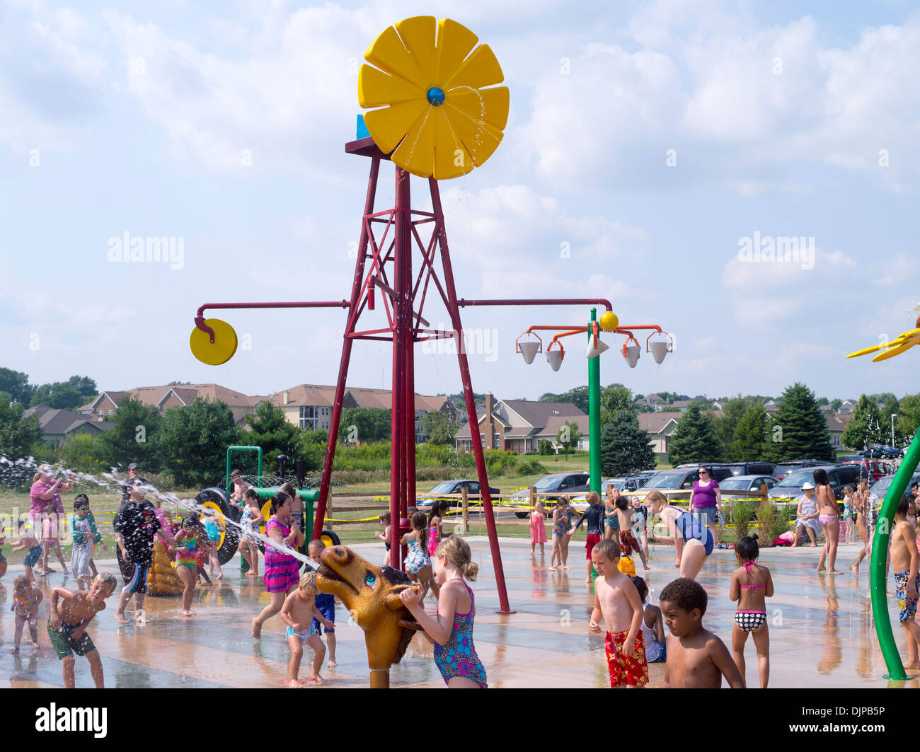 Children and adults play at the new Splash Pad located at McKee Farms