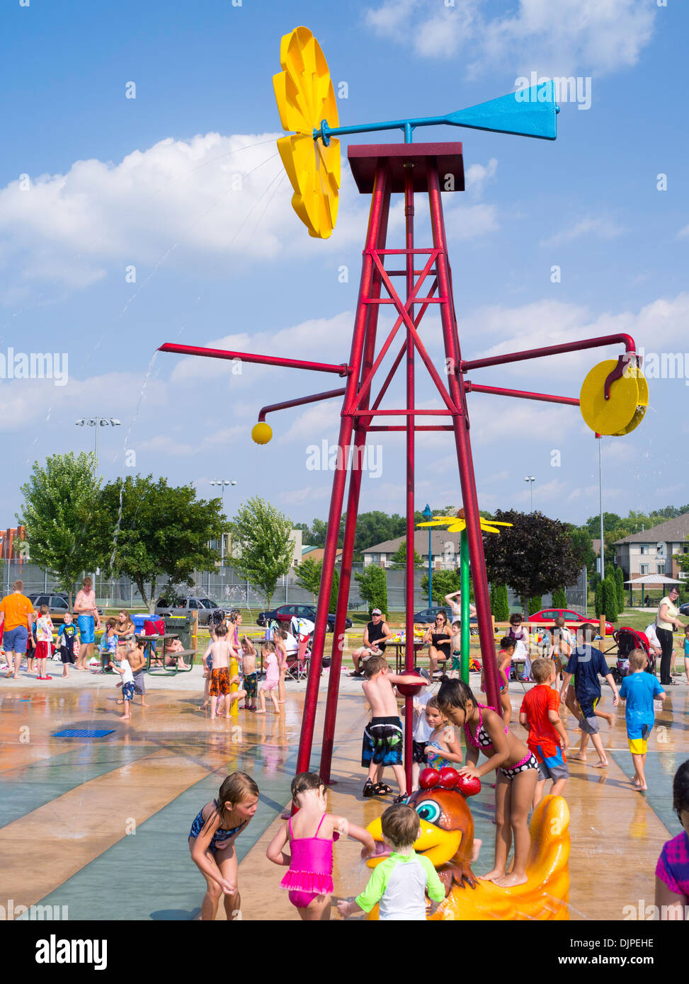 Children and adults play at the new Splash Pad located at McKee Farms
