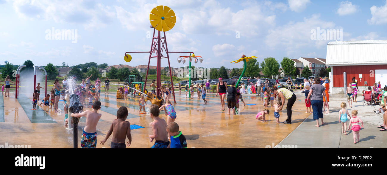 Children and adults play at the new Splash Pad located at McKee Farms