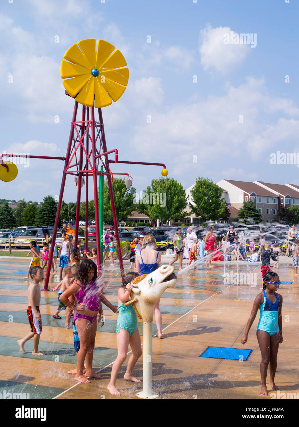 Children and adults play at the new Splash Pad located at McKee Farms