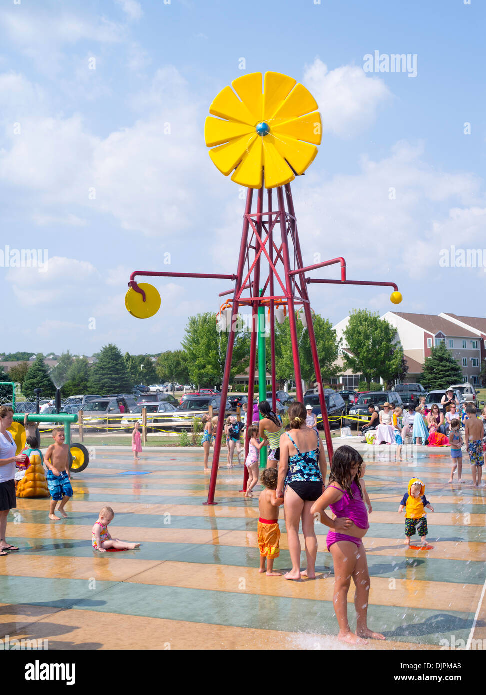 Children and adults play at the new Splash Pad located at McKee Farms