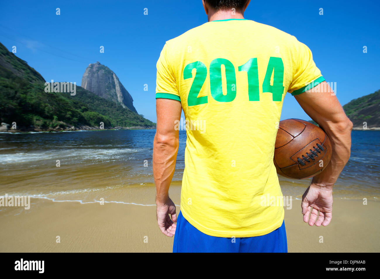 Brazil 2014 soccer player stands with old football at Sugarloaf Pao de Acucar in Rio de Janeiro Brazil Stock Photo