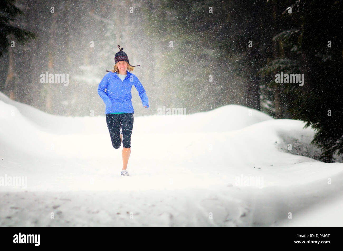 Apr. 01, 2010 - Spokane, Washington, USA - Sara Ranson is an elite runner with the running club Team Swift based out of Spokane, Washington. She runs at Mt. Spokane Ski Resort on a snowy spring day dressed in winter running gear and running through evergreen trees, snow, trails on a cloudy winter like day. (Credit Image: © Jed Conklin/ZUMApress.com) Stock Photo