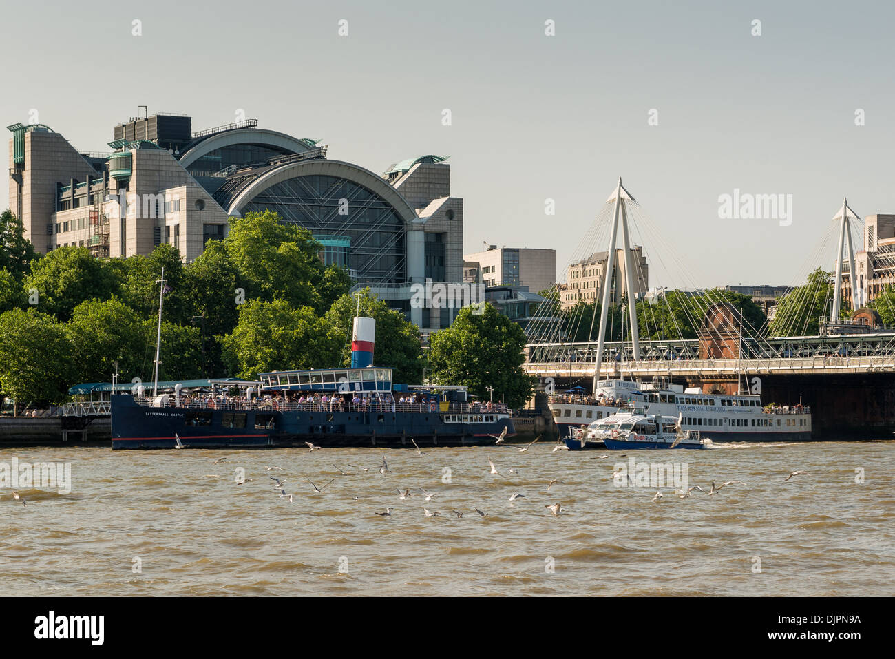 Seagulls on the Thames, river traffic, pleasure boats and Charing Cross station Stock Photo