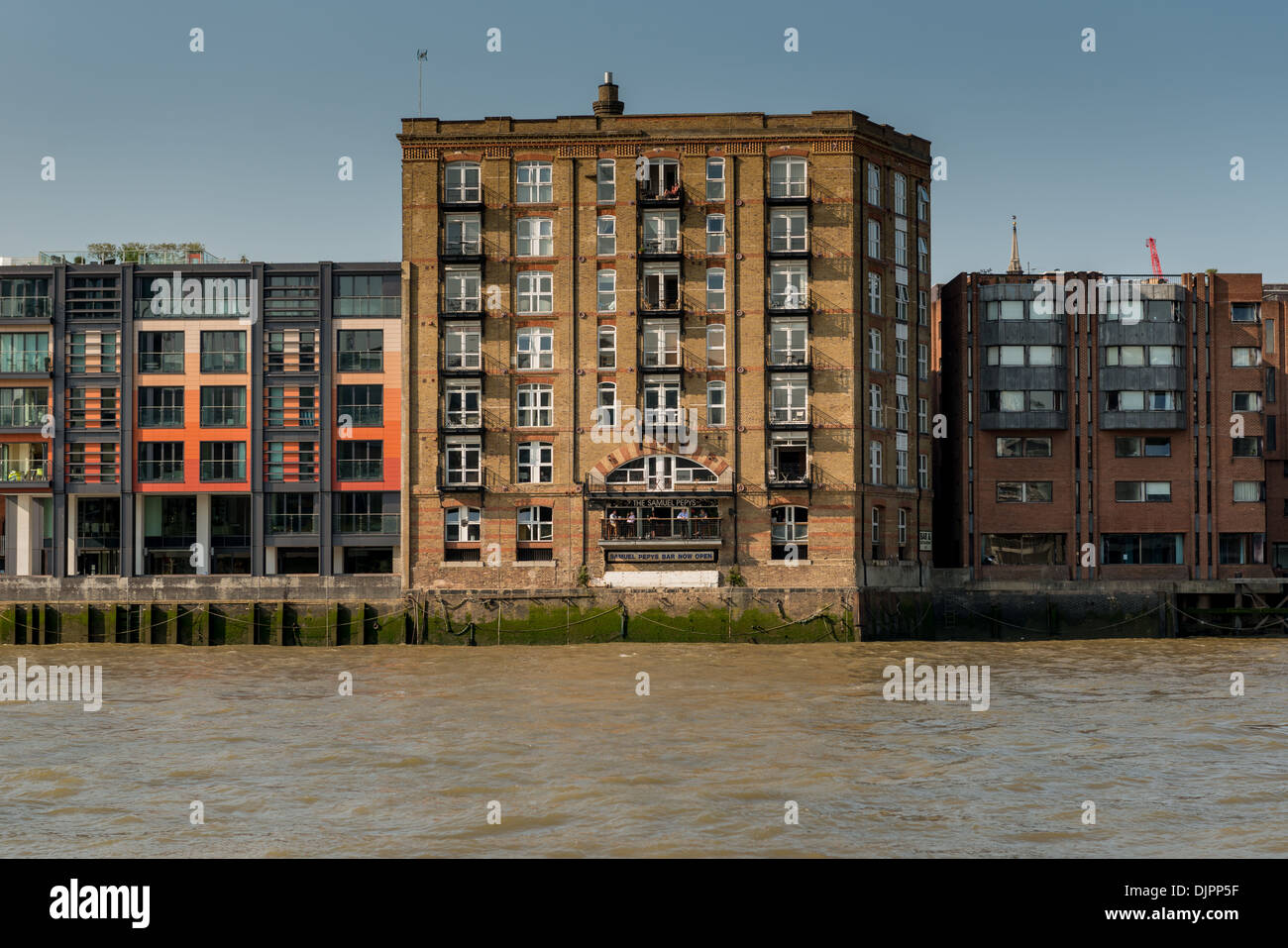 A river cruise along the Thames, passing Samuel Pepys Bar & Restaurant in a converted warehouse conversion Stock Photo