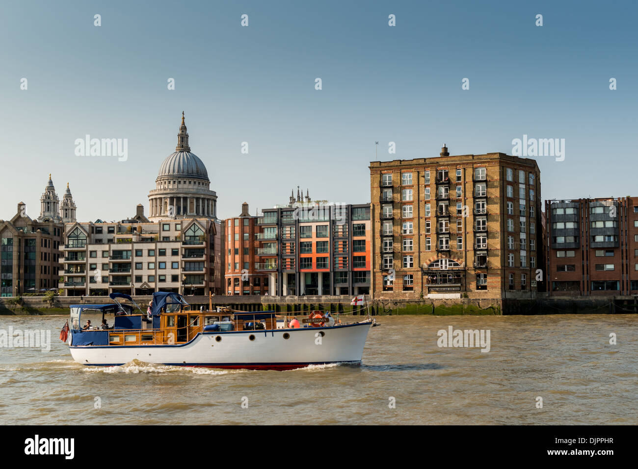 Boat on River Thames passing St Paul's Cathedral Stock Photo