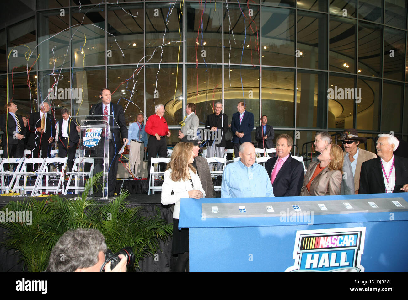 May 11, 2010 - Charlotte, North Carolina, U.S. - Grand Opening of the Nascar Hall of Fame festivities saw from left, TERESA EARNHARDT, RON HORNADAY JR., JACK INGRAM, DARELL WALTRIP, LISA FRANCE KENNEDY, BRIAN FRANCE (behind Lisa France Kennedy), RICHARD PETTY and JUNIOR JOHNSON along with WINSTON KELLY at the podium welcome guests to the newly opened Hall of Fame. The Nascar Hall o Stock Photo