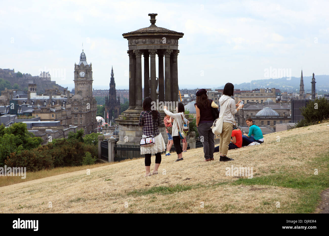 Tourists near the Dugald Stewart Monument on Calton Hill in Edinburgh Stock Photo