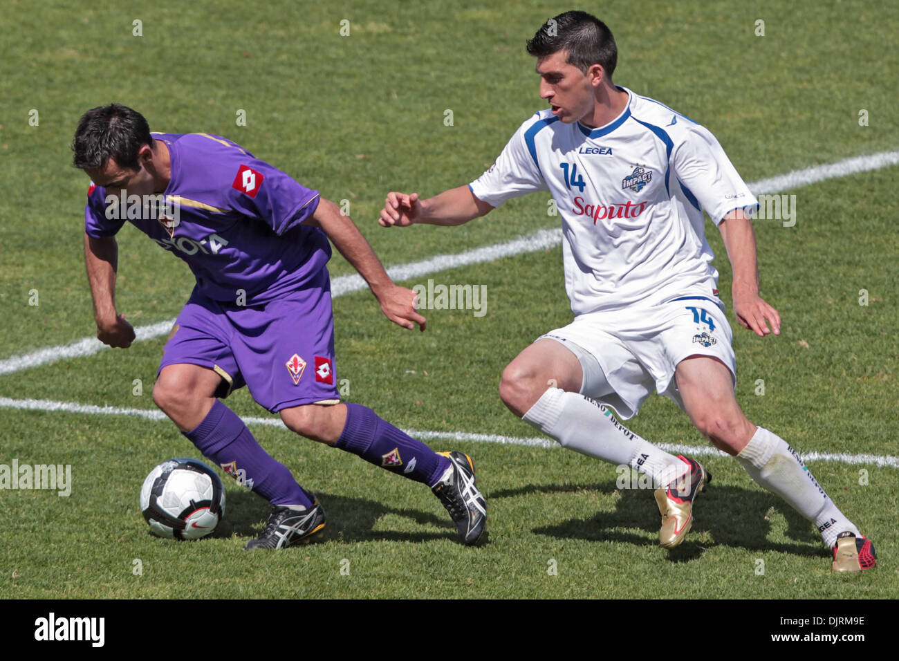 May 23, 2010 - Montreal, Quebec, Canada - 23 May 2010:  Fiorentina's midfielder Marco Marchionni (#32) and Montreal Impact's midfielder Tony Donatelli(#14) battle for the ball in game action during the second half of play of the FIFA game between AFC Fiorentina and the Montreal Imapct played at Saputo Stadium in Montreal, Canada. The game ended in a 1-1 tie..Mandatory Credit: Phili Stock Photo