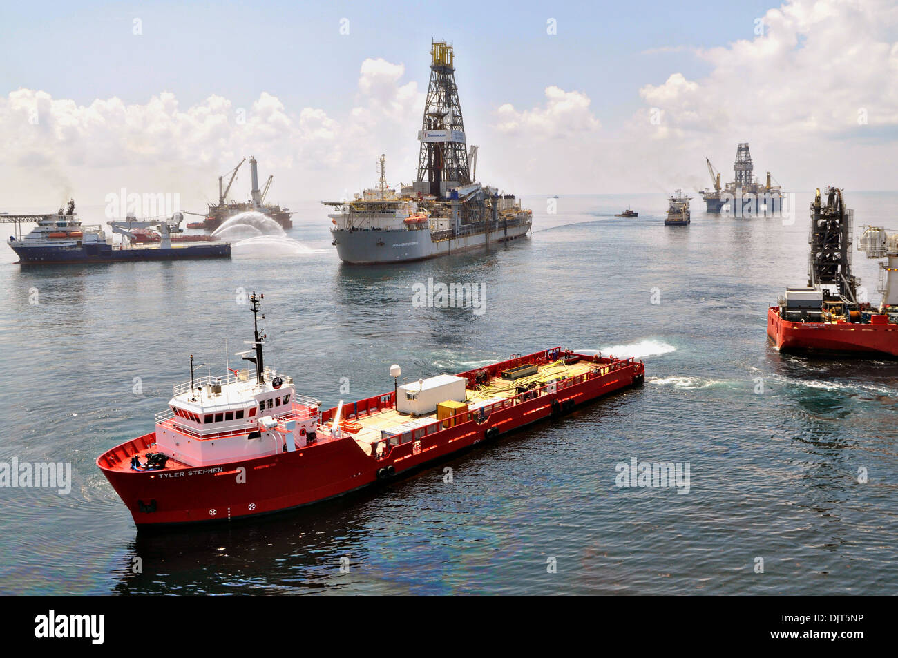 Ships and drilling rigs surrounding the Discoverer Enterprise as it recovers oil from the Deepwater Horizon drill site June 15, 2010 in the Gulf of Mexico. The spill considered the largest accidental marine oil spill in the history of the petroleum industry. Stock Photo