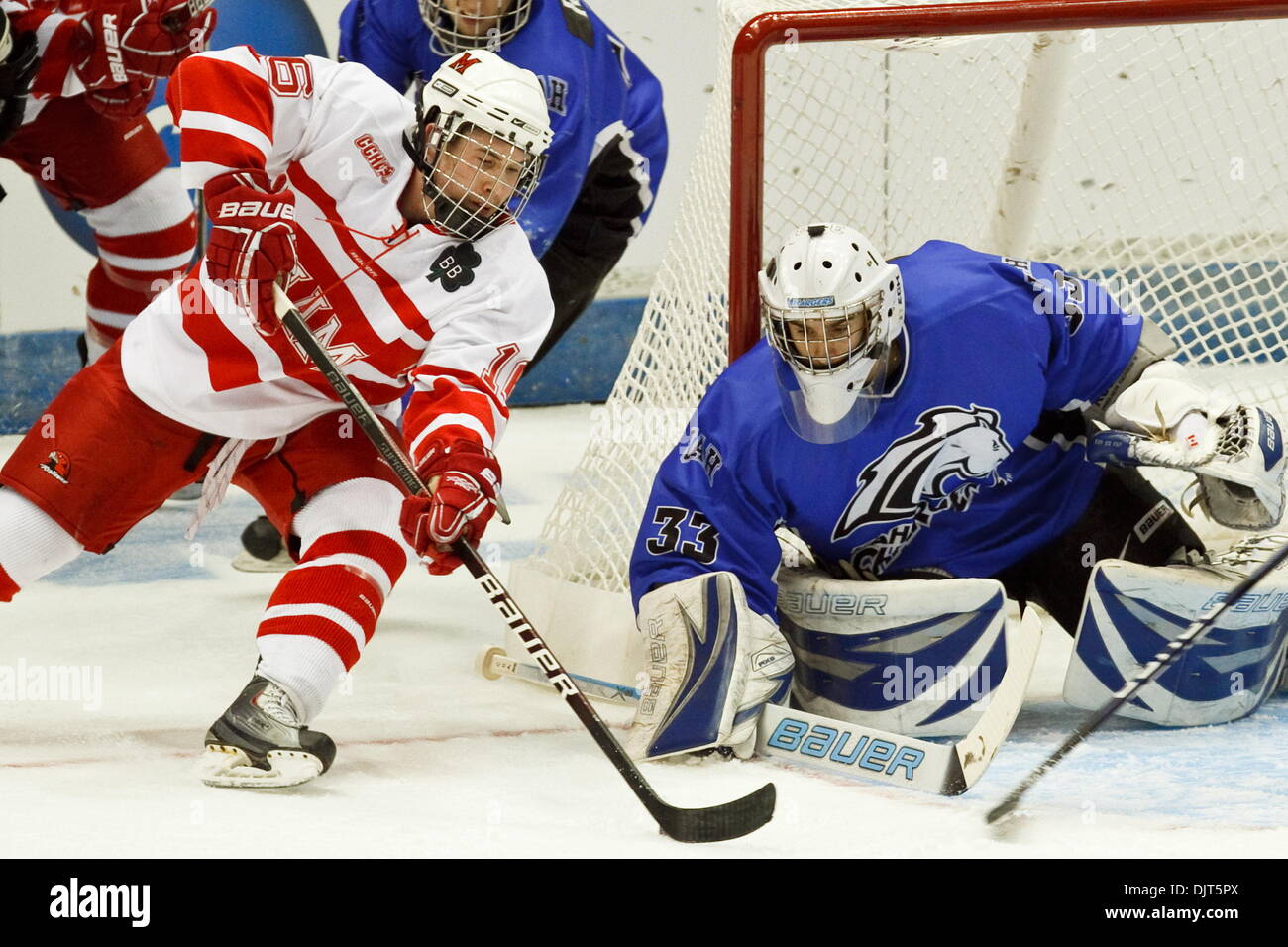 Miami left winger Curtis Mckenzie (16) tries to shoot the puck past