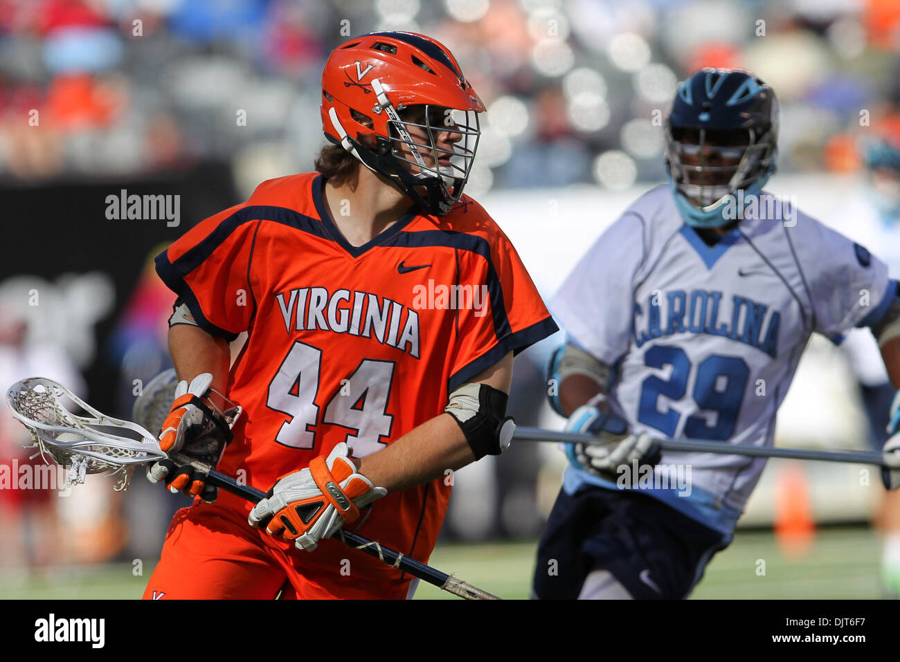 Virginia Midfielder Chris LaPierre (44) cradles as North Carolina Defenseman Milton Lyles (29