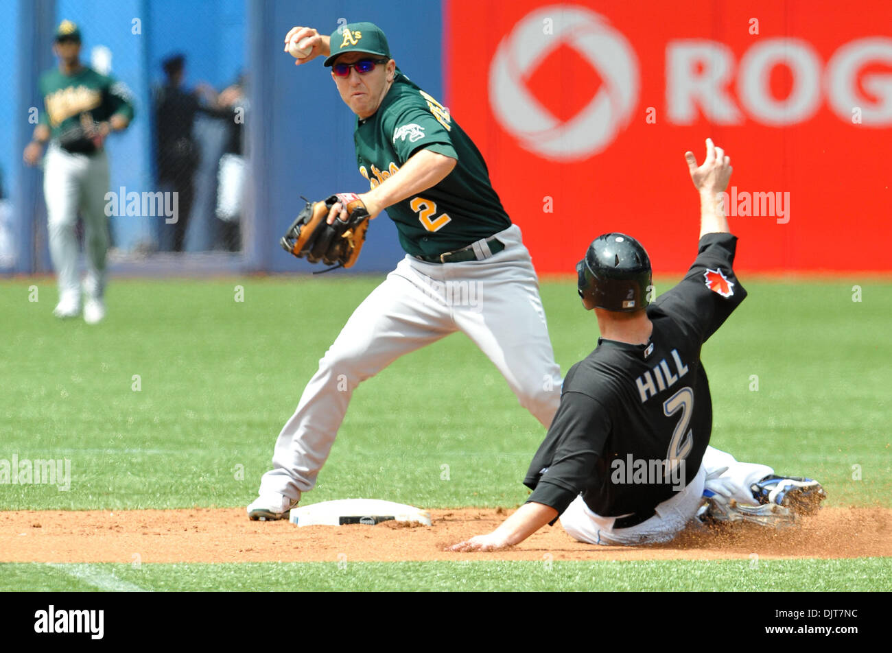 May 02, 2010 - Toronto, Ontario, Canada - 2 May 2010: Oakland Athletics' second basemen Cliff Pennington (2) turns the double play as Toronto Blue Jays second baseman Aaron Hill (2) slides under during game action. The Blue Jays defeated the Athletics 9-3 at the Rogers Centre in Toronto, Ontario. (Credit Image: © Adrian Gauthier/Southcreek Global/ZUMApress.com) Stock Photo