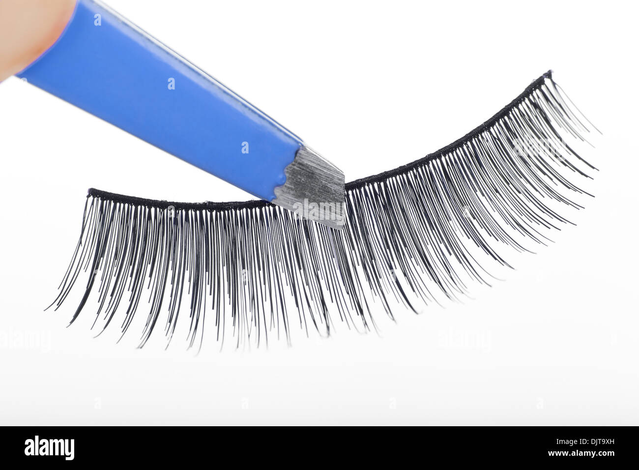 False lashes and blue pincers, closeup on white background  Stock Photo