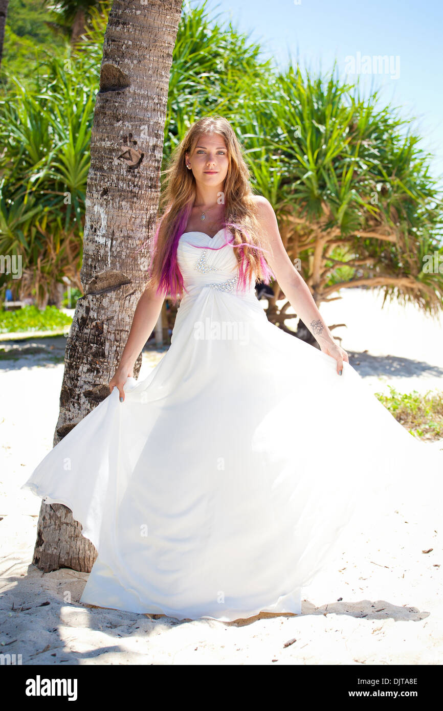 Beautiful bride in wedding dress on tropical beach Stock Photo - Alamy